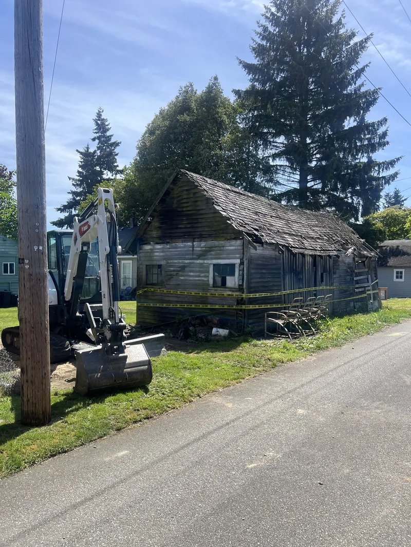 Condemned 100-year-old shed with caution tape before demolition in Everett, WA