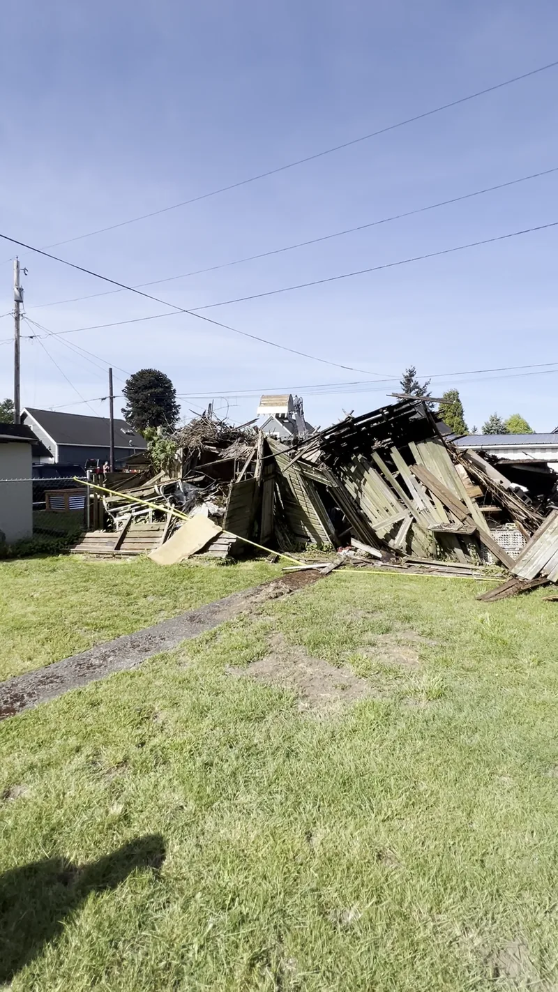 Shed brought down to a debris pile during controlled demolition