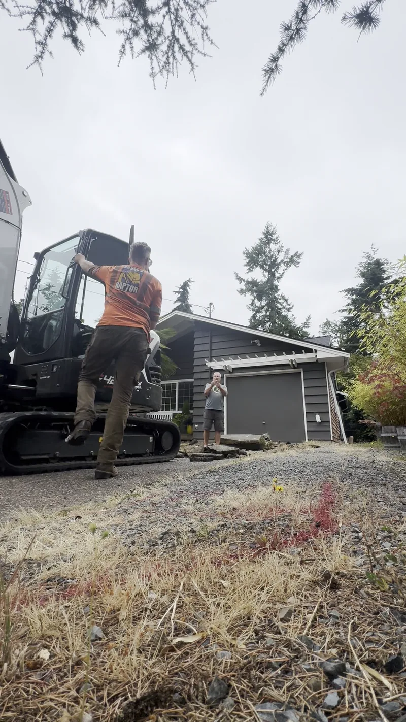 DirtRaptor crew operating an excavator on a driveway removal job